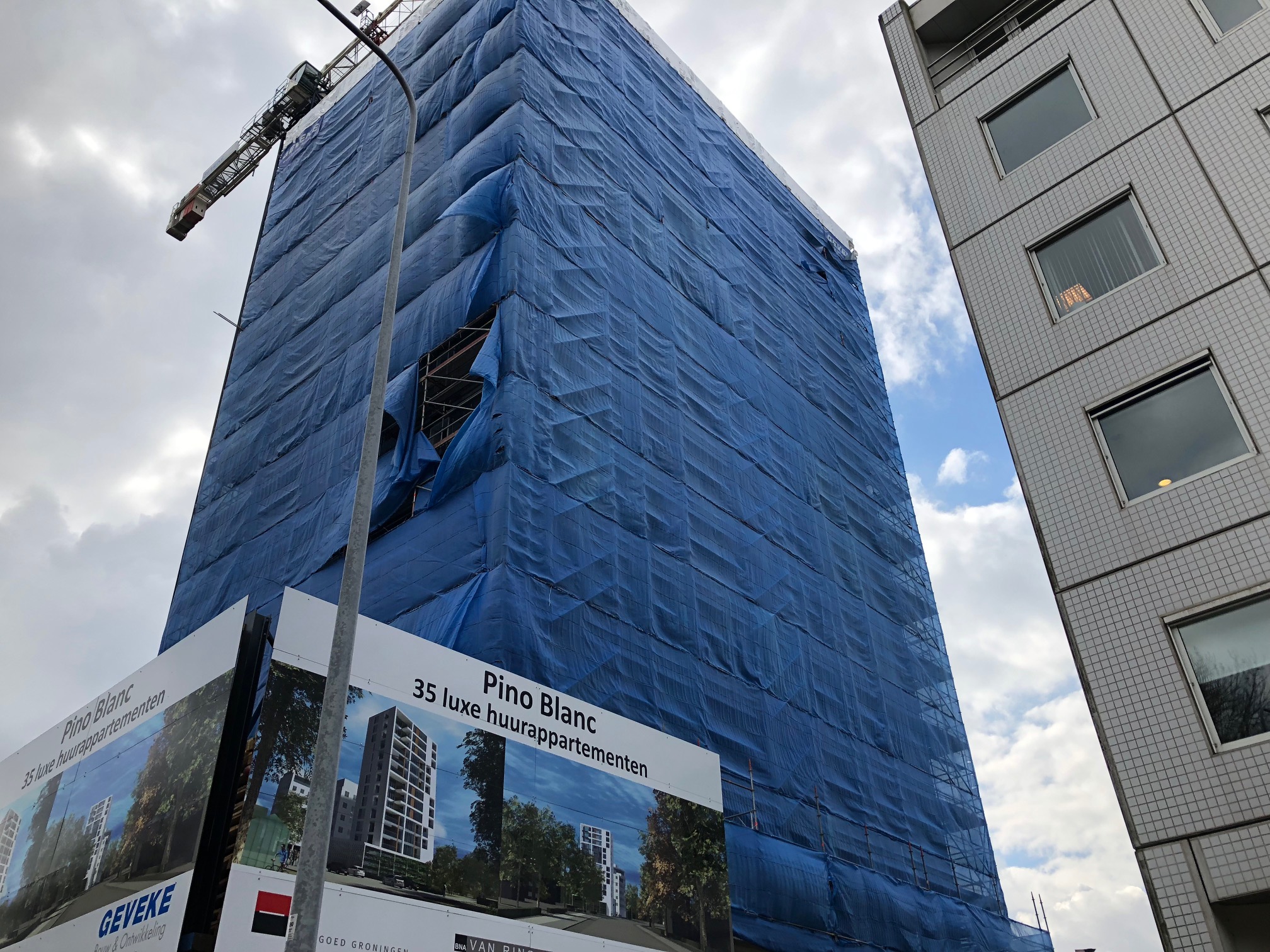 De bovenste foto's zijn van artist impressies, en de onderste is van de huidige situatie. In de loop van dit jaar zal het plastic worden verwijderd en wordt het gebouw zichtbaar.